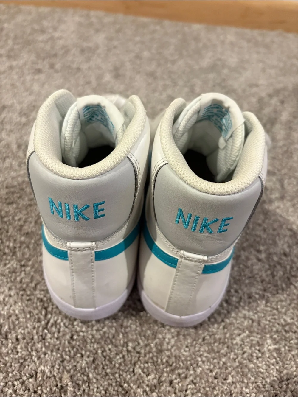 Nike White High-Top Sneakers with Teal Swoosh Accents
